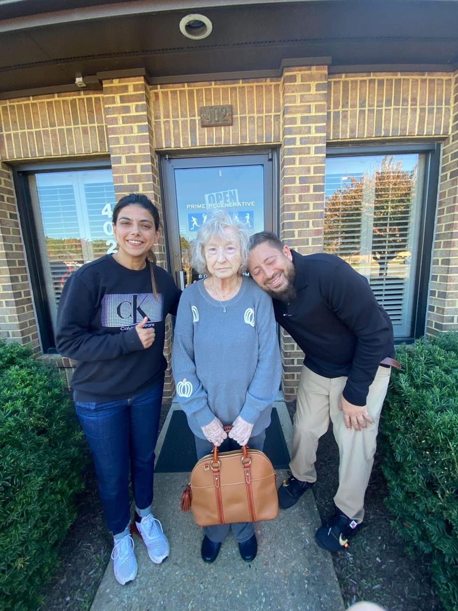 The Real Hope team with a homeowner outside an office